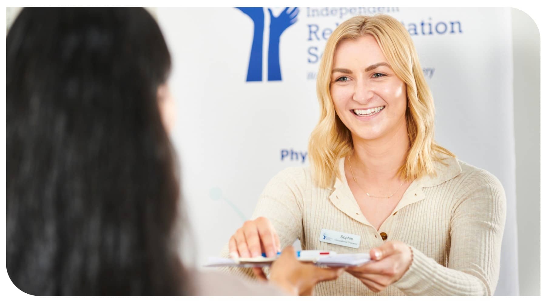 Female smiling and receiving a clipboard from client