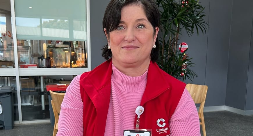 A woman in her Caulfield Hospital volunteering uniform
